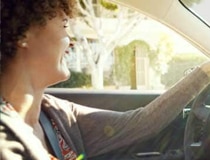 A profile shot of a woman driving.